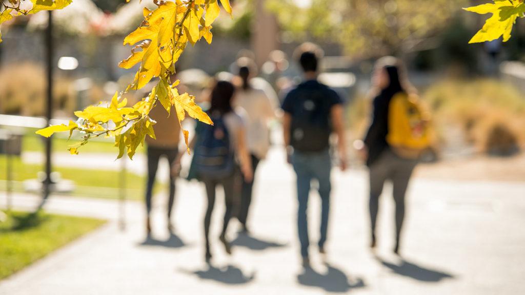 Students walking down a sidewalk